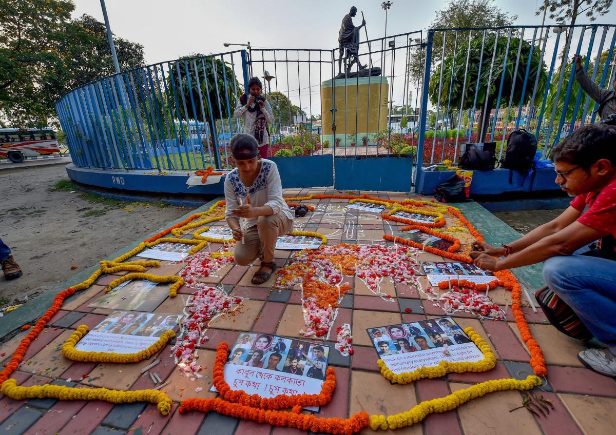 Journalists pay tribute to media personnel who lost their lives in Kabul's double suicide bombing in Kolkata on Wednesday. PTI Photo