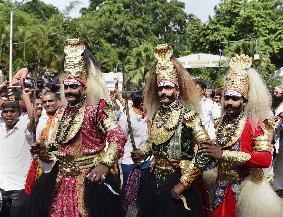Folk artists join BJP supporters as they celebrate the swearing-in of new Karnataka Chief Minister B S Yeddyurappa, outside Raj Bhavan in Bengaluru, on Thursday. PTI Photo