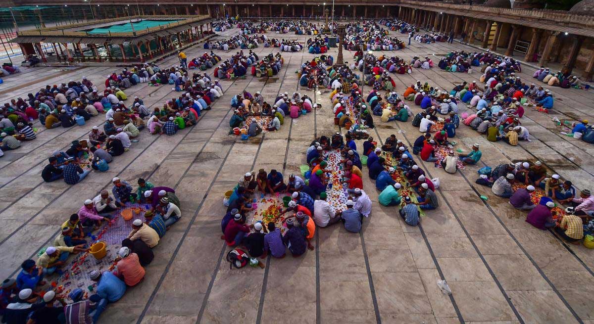 Muslims break their fast at dusk on the first day of Ramadan, in Ahmedabad, on Thursday. PTI Photo