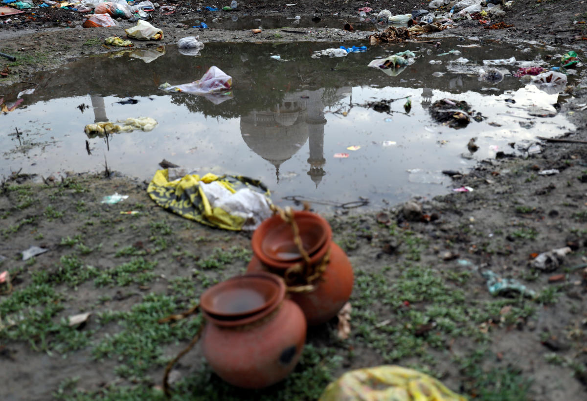 The dome and a minaret of the historic Taj Mahal are reflected in a puddle on the polluted banks of the river Yamuna in Agra. Reuters Photo