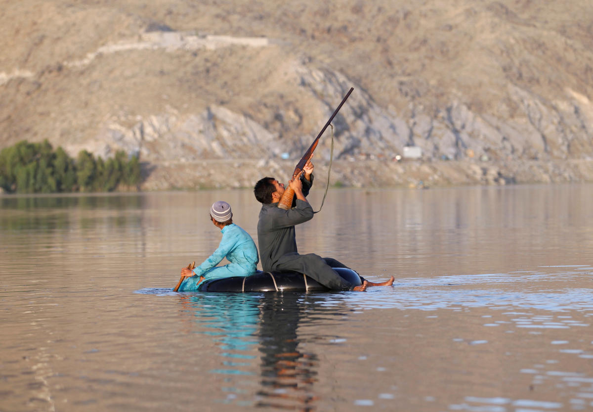 An Afghan hunter shoots at a duck in Laghman province, Afghanistan May 30, 2018.REUTERS/Parwiz