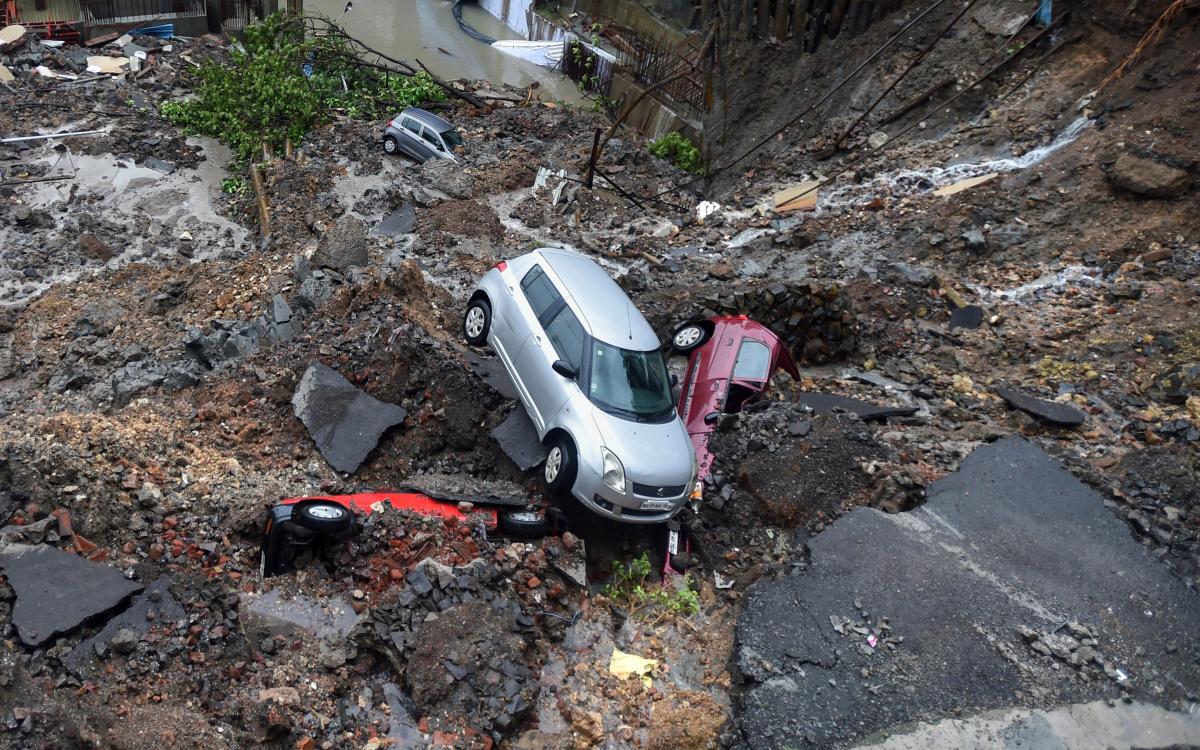 Several cars struck in debris after a wall collapsed at a construction site in Antop Hill, Wadala East area, in Mumbai on Monday, June 25, 2018. PTI