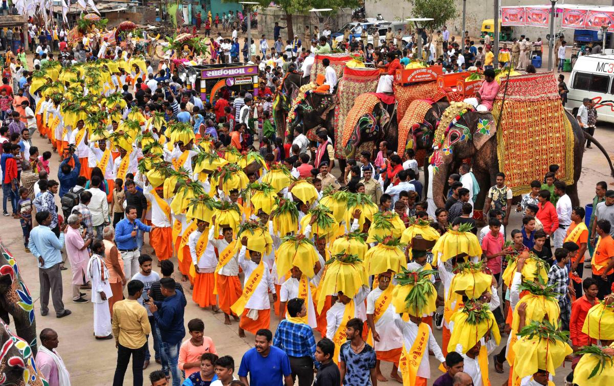 Hindu devotees carry pitchers filled with holy water from Sabarmati River during Jal Yatra procession ahead of the annual Rath Yatra, in Ahmedabad on Thursday, June 28, 2018. PTI