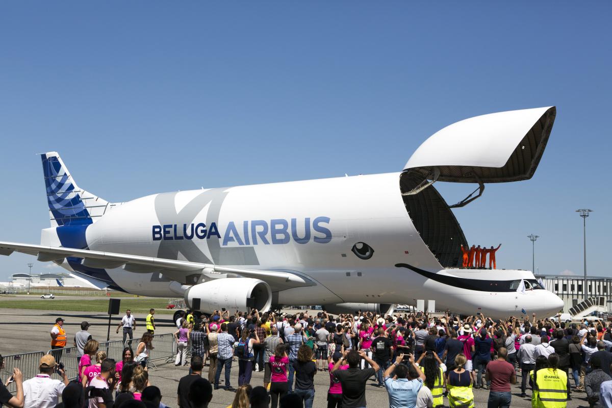 Engineers wave from the deck of the Airbus BelugaXL after successfully completing its first flight at Toulouse-Blagnac airport, in Toulouse, southern France. (AP/PTI Photo)