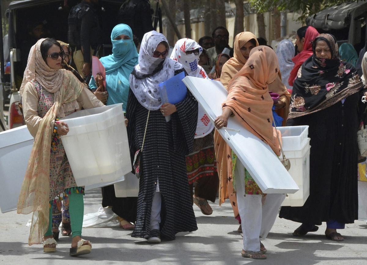 Pakistani election workers collect ballot boxes and polling material from a distribution center in Quetta, Pakistan. (AP/PTI Photo)