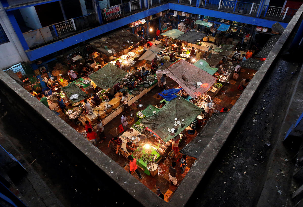 Vendors sell fish at a retail fish market in Kolkata. (Reuters Photo)
