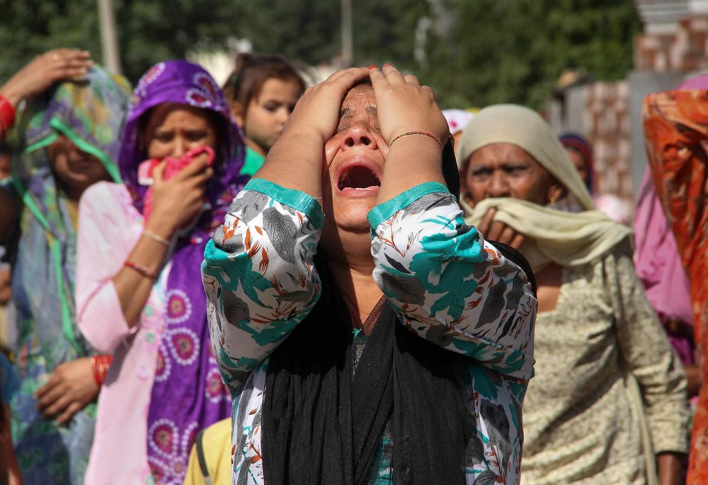 Family members mourn the death of rifleman Rajat Kumar Basan, who was killed along the LoC in the firing from Pakistan side, at Pallanwala village in Akhnoor Sector about 65km from Jammu, Monday. Three army men and two militants were killed in a gunfight near the Line of Control (LoC) in Sunderbani area of Rajouri district on Sunday. PTI Photo