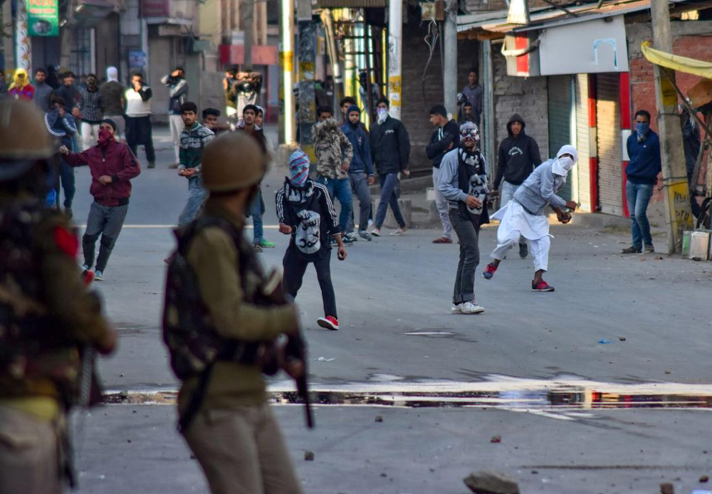 Protesters pelt stones at the police during a clash, in Srinagar, Monday. The protest was over the death of seven civilians in the Kulgam blast. PTI Photo