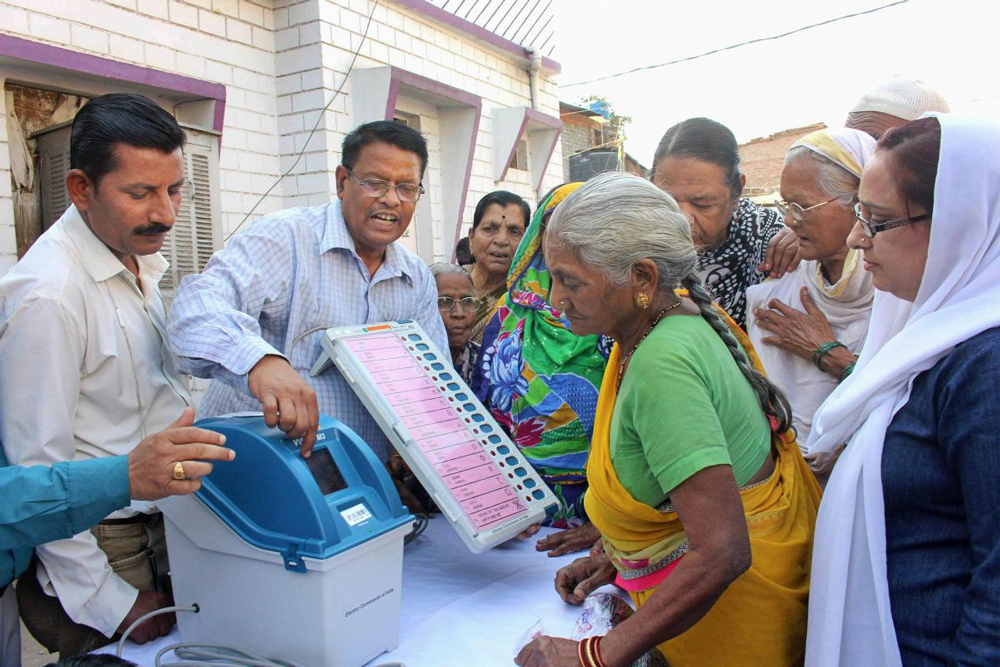 Poll officials demonstrate how to use Electronic Voting Machine (EVM) and Voter-Verified Paper Audit Trail (VVPAT) during a voter awareness programme ahead of State Assembly elections, in Bhopal, Monday. PTI Photo