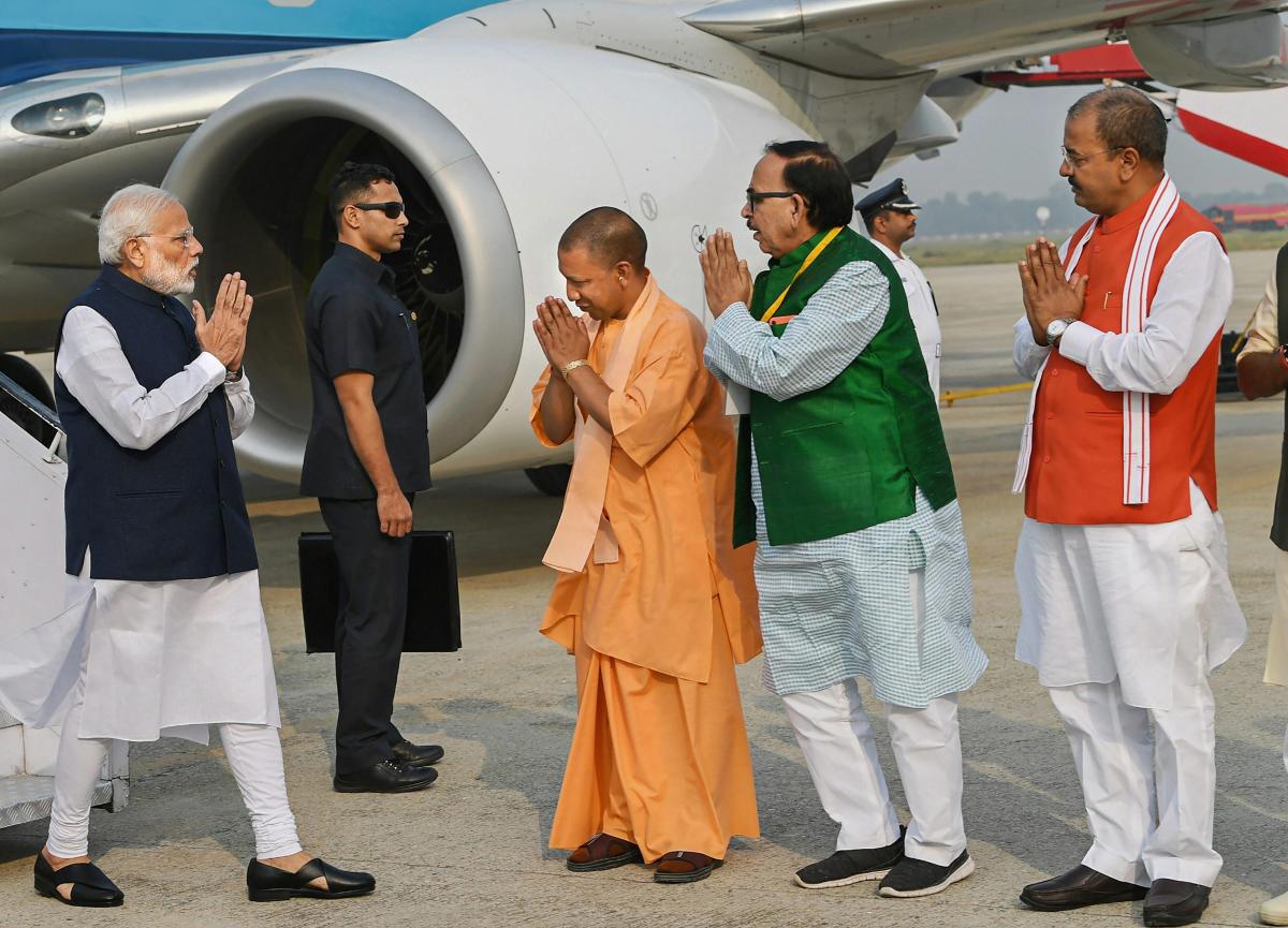 Prime Minister Narendra Modi being received by Uttar Pradesh Chief Minister Yogi Adityanath, UP BJP chief Mahendra Nath Pandey and UP Deputy Chief Minister Keshav Prasad Maurya on his arrival, in Varanasi, Monday, Nov 12, 2018. (PIB Photo via PTI)