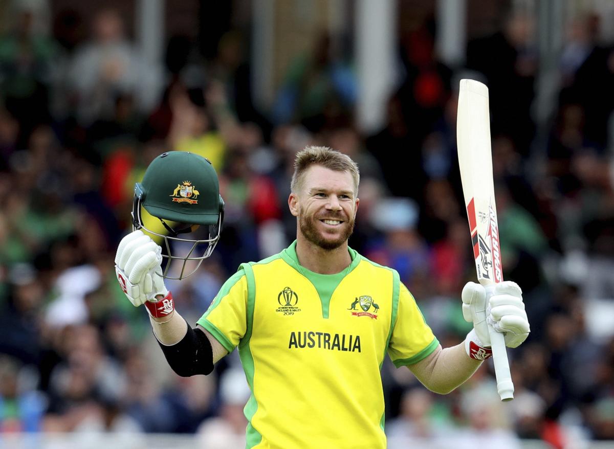 Australia's David Warner raises his bat and helmet to celebrate scoring a century during the Cricket World Cup match between Australia and Bangladesh at Trent Bridge in Nottingham, Thursday, June 20, 2019. AP/PTI