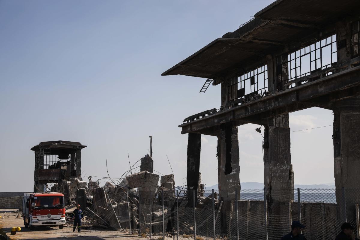 Firefighters search for trapped people at a damaged structure following an earthquake at the port of Piraeus, near Athens. (AP/PTI Photo)
