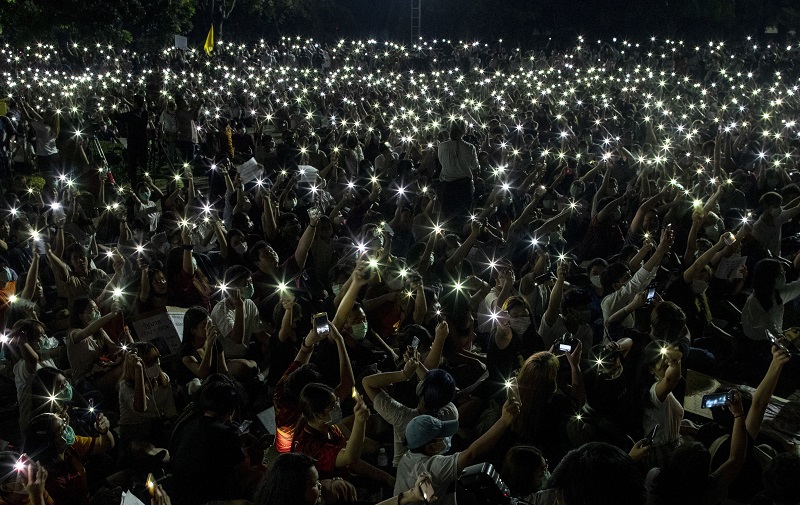 Pro-democracy students wave mobile phones with flashlights switched on, during a large rally at Thammasat University in Pathum Thani, north of Bangkok. (PTI Photo)