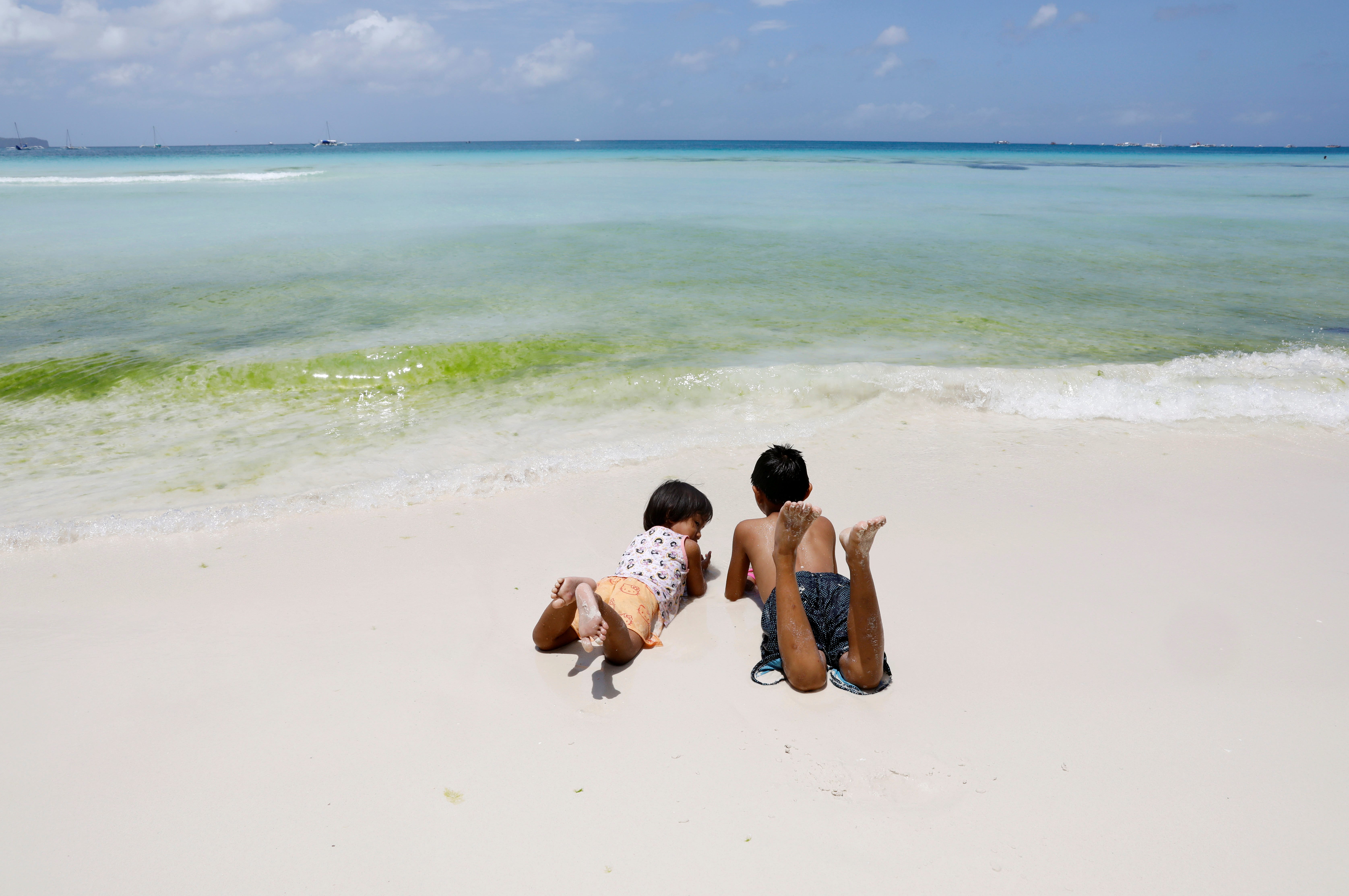 Children frolic in a beach in Philippines. (Credit: Reuters Photo)