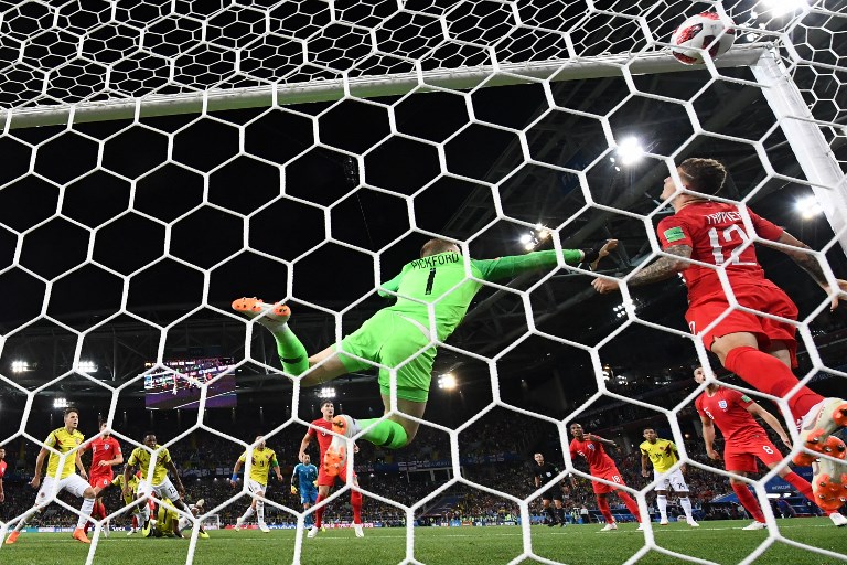 Colombia's defender Yerry Mina (3rd L) reacts as he scores a goal while England's goalkeeper Jordan Pickford (C) jumps to catch it during the Russia 2018 World Cup round of 16 football match between Colombia and England at the Spartak Stadium in Moscow on July 3, 2018.  FRANCK FIFE / AFP