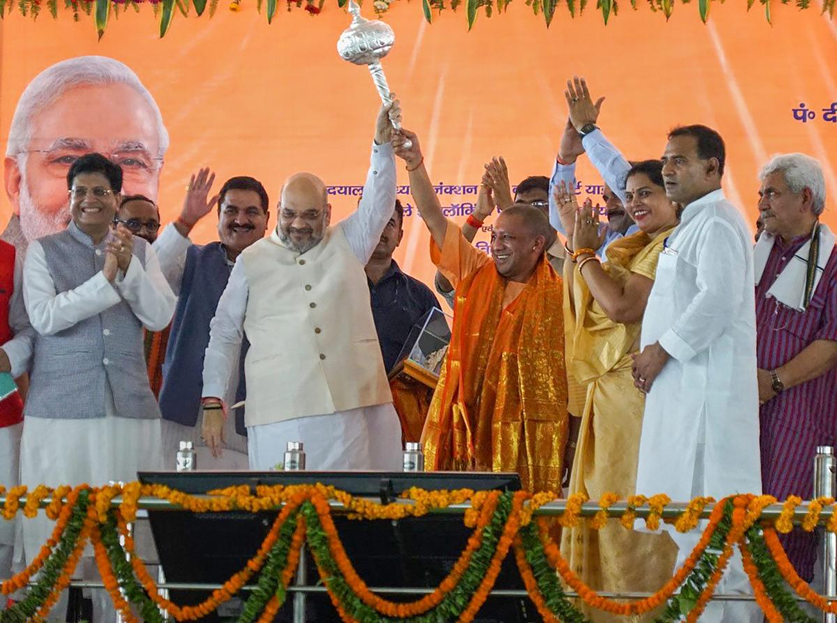 BJP National President Amit Shah (2ndR), Railway Minister Piyush Goyal(L) and Uttar Pradesh Chief Minister Yogi Adityanath (3rdL) during the inauguration of a new train at Pandit Deen Dayal Upadhyay station (previously known as Mughalsarai railway station), in Mughalsarai on Sunday. PTI photo