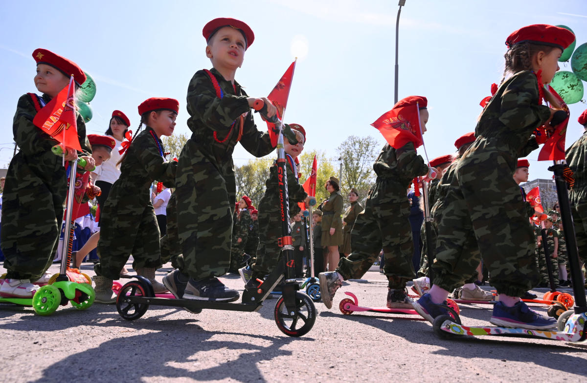 Children wearing military uniform ride kick scooters during a parade, held by Russian servicemen, pupils of infant and primary schools, which is a public event to honour World War Two veterans and to mark the upcoming Victory Day, in Rostov-on-Don, Russia April 25, 2019. REUTERS/Sergey Pivovarov