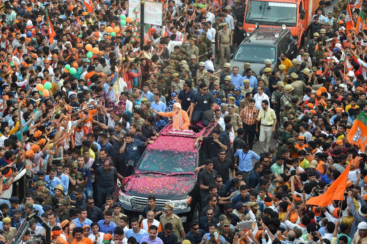 Prime Minister Narendra Modi waves at supporters during his roadshow, a day ahead of filing his nomination papers for the Lok Sabha polls, in Varanasi, Thursday, April 25, 2019. (PTI Photo/Manvender Vashist)