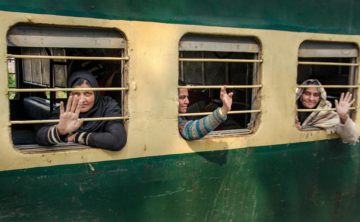 Passengers from Pakistan wave at media persons as they arrive by Samjhauta Express in Attari, Monday, March 4, 2019. Pakistani authorities restored the Samjhauta Express services between Lahore and Delhi today, days after the train was suspended due to tense bilateral ties. PTI