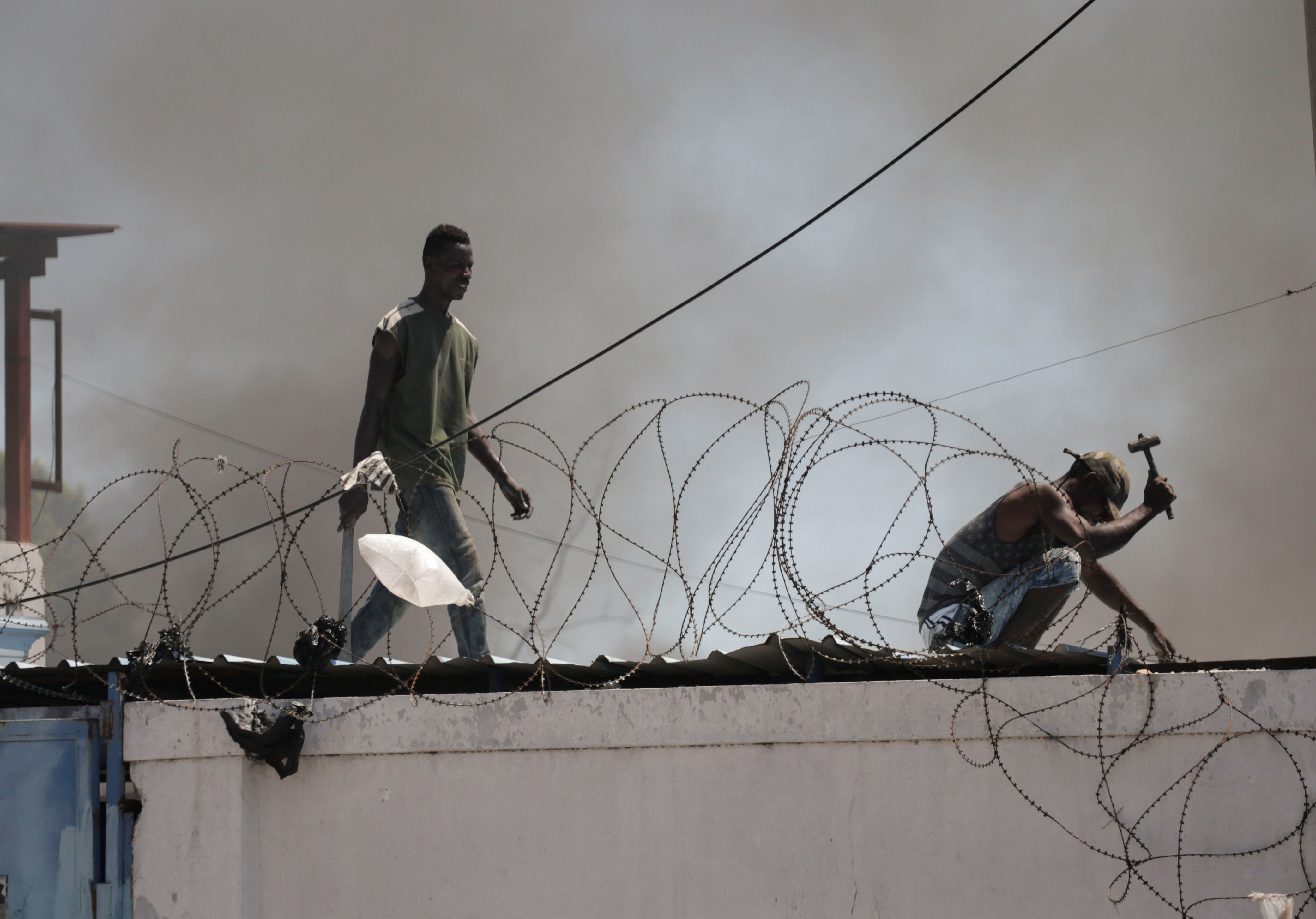 Protesters are seen in a police station during a demonstration demanding the resignation of Haitian President Jovenel Moise in Port-au-Prince, Haiti. (Reuters)