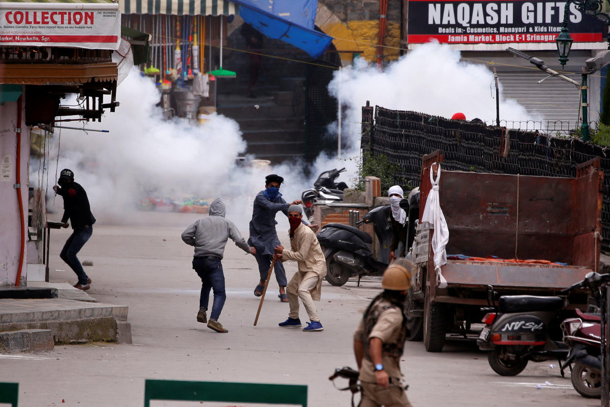 Indian police officer chases demonstrators during a protest against the recent killings of Palestinian protesters on the Gaza-Israel border and the U.S. embassy move to Jerusalem, in Srinagar. Reuters Photo