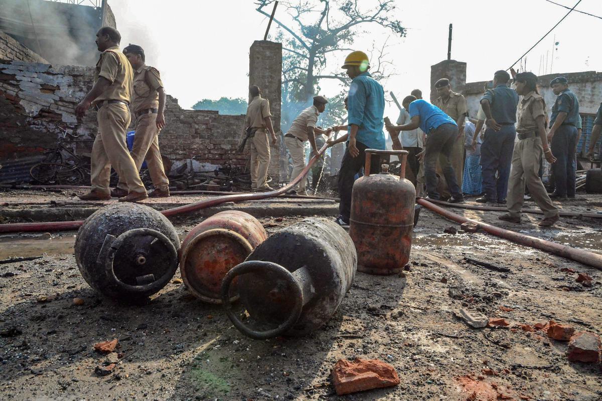 Firemen try to control a fire which broke out in a cylinder storage unit in Didarganj area of Patna. PTI Photo
