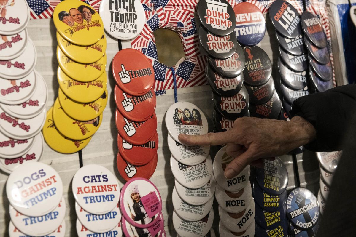 A supporter of Democratic Presidential Candidate Sen. Bernie Sanders points to a button while waiting in line for Sanders campaign rally at the TCF Center on March 6, 2020 in Detroit, Michigan. Senator Sanders discussed various topics including the differences between his and former Vice President Joe Bidens agenda after Bidens victories on Super Tuesday. Brittany Greeson/Getty Images/AFP