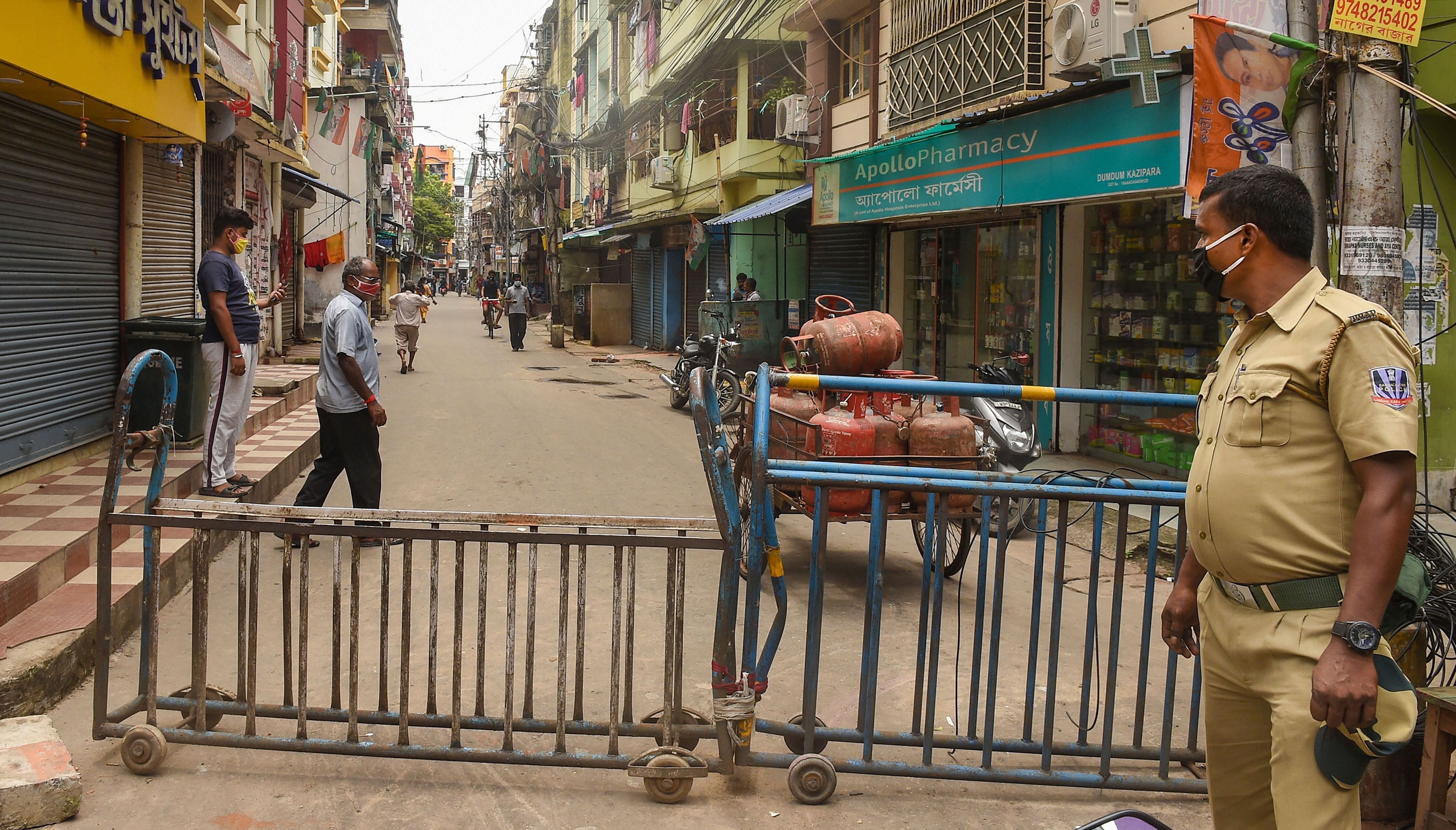 A police man guards outside a sealed locality after surge in Covid-19 cases, during Unlock 2.0 in Kolkata. Credits: PTI Photo