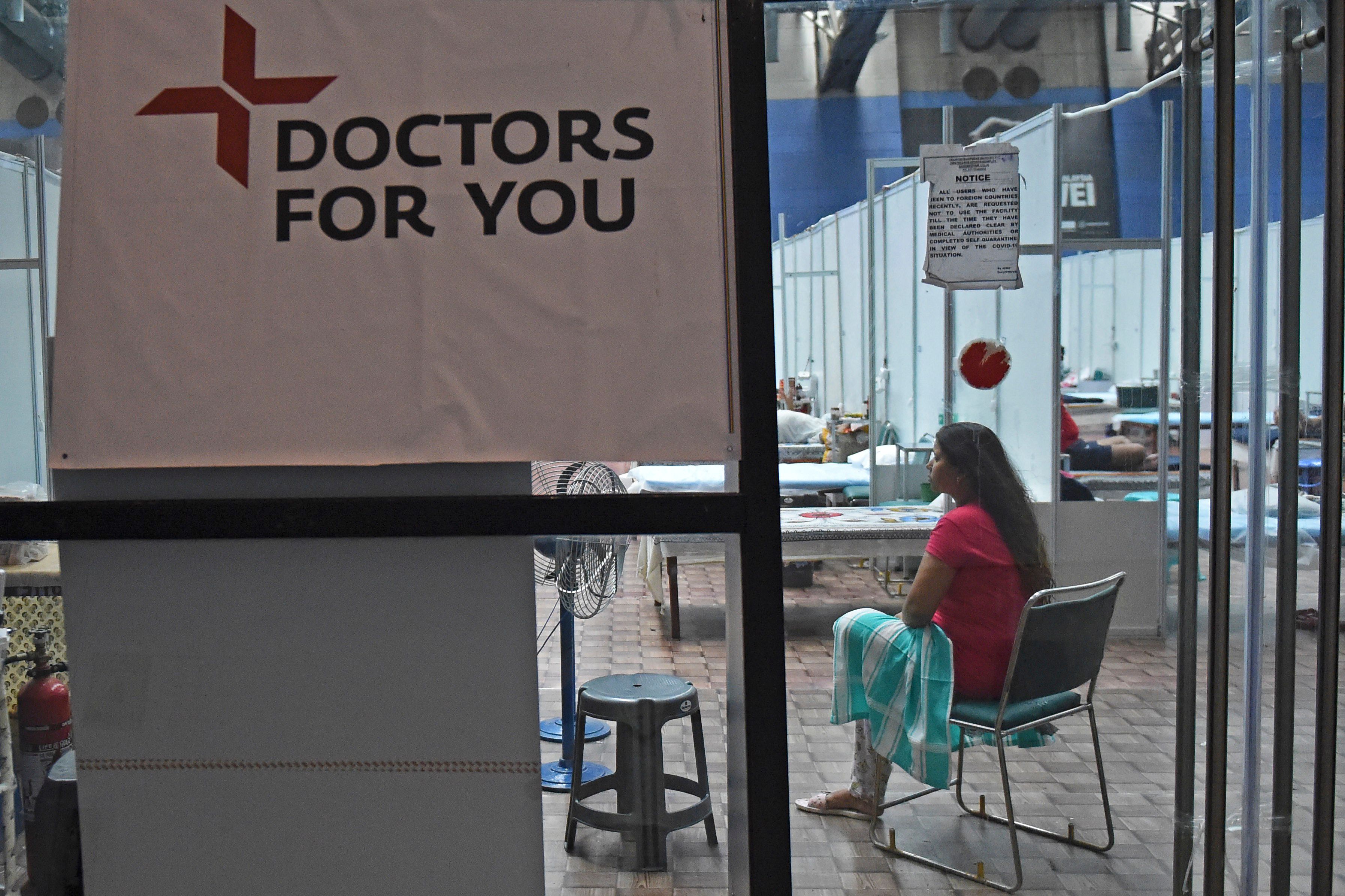 A patient sits inside a ward at the Commonwealth Games (CWG) Village sports complex, temporarily converted into COVID-19 coronavirus care centre, in New Delhi . Credit: AFP Photo