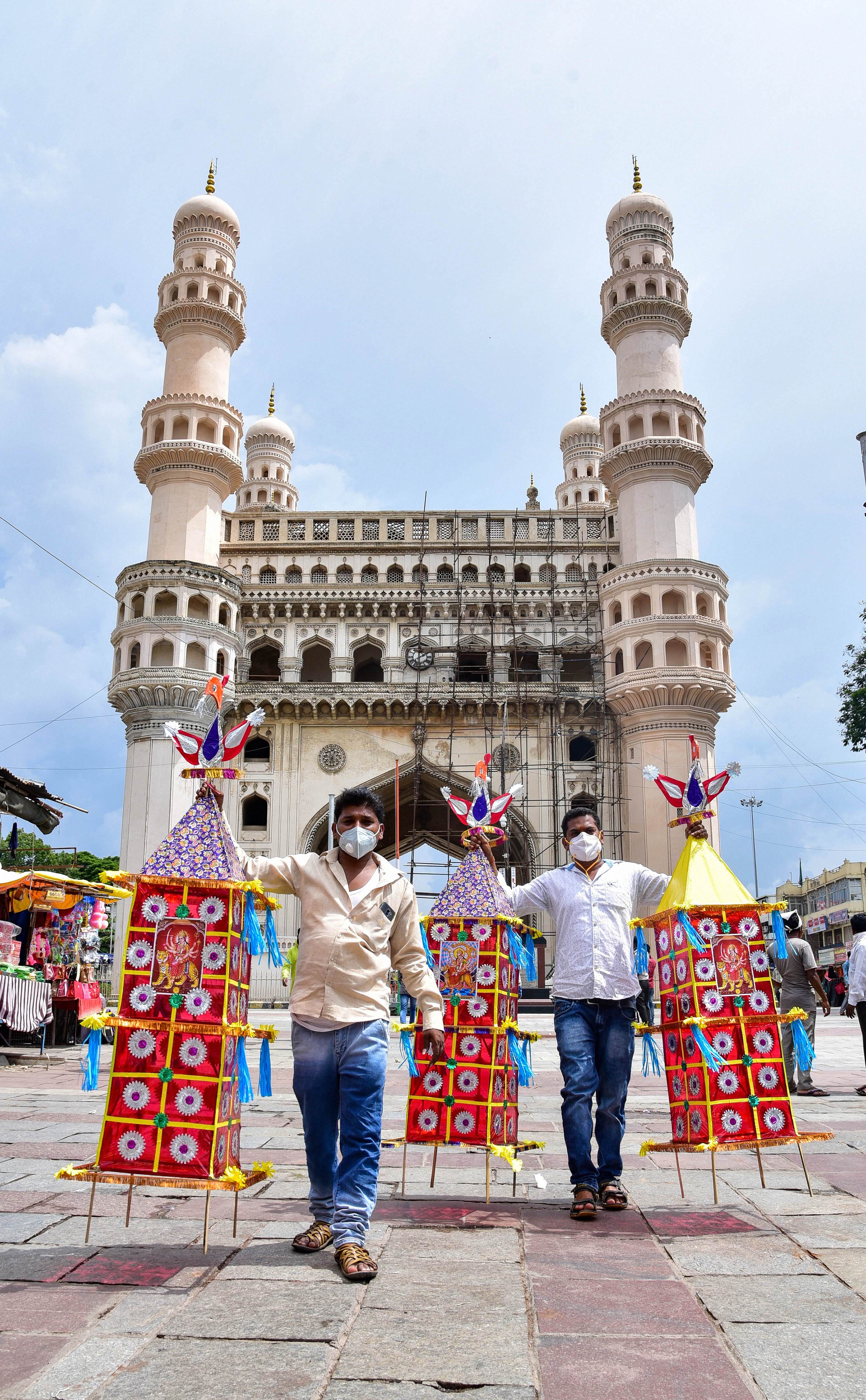 Devotees hold 'Thotala' during the Bonalu festival, at Charminar, Sunday, July 19, 2020. Credit: PTI Photo
