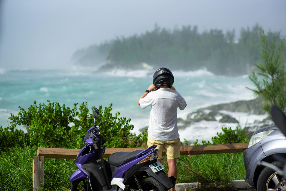 A motorcyclist watches the waves as Hurricane Teddy approaches Bermuda on the South Shore in Smith's Parish. Credit: Reuters Photo