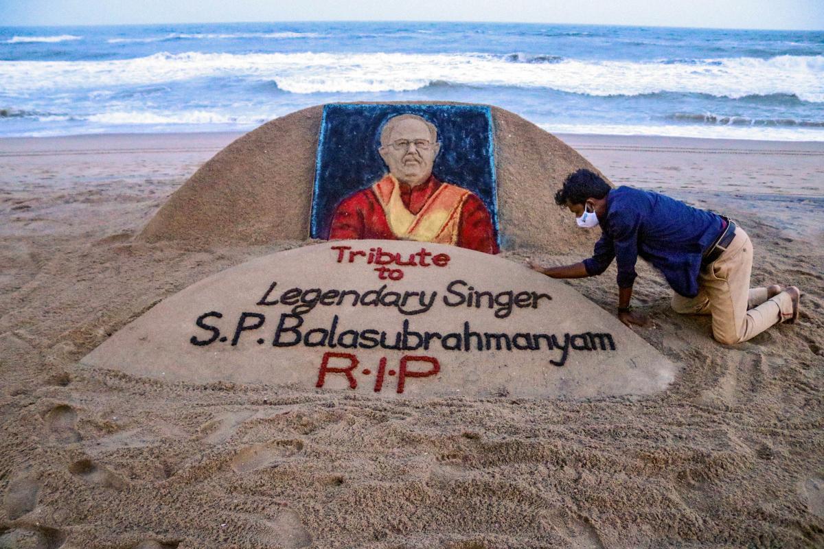 Sand artist Sudarsan Pattnaik gives final touch to a sand sculpture in memory of legendary singer S P Balasubramanyam, who passed away today, at Puri beach, Odisha. Credit: PTI Photo