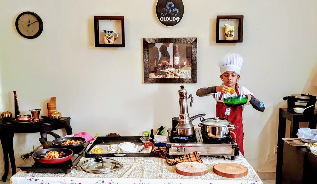 Saanvi M Prajit, daughter of Wing Commander of Indian Air Force Prajit Babu and Manjma hailing from Ernakulam, who has been recognised by the Asia Book of Records and the India Book of Records, prepares food, in Kochi. Credit: PTI Photo