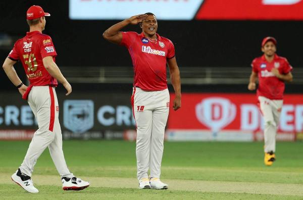 Kings XI Punjab bowler Sheldon Cottrell performs a salute after dismissing Royal Challengers Bangalore (RCB) batsman Devdutt Padikkal during IPL 2020 cricket match. Credit: PTI Photo