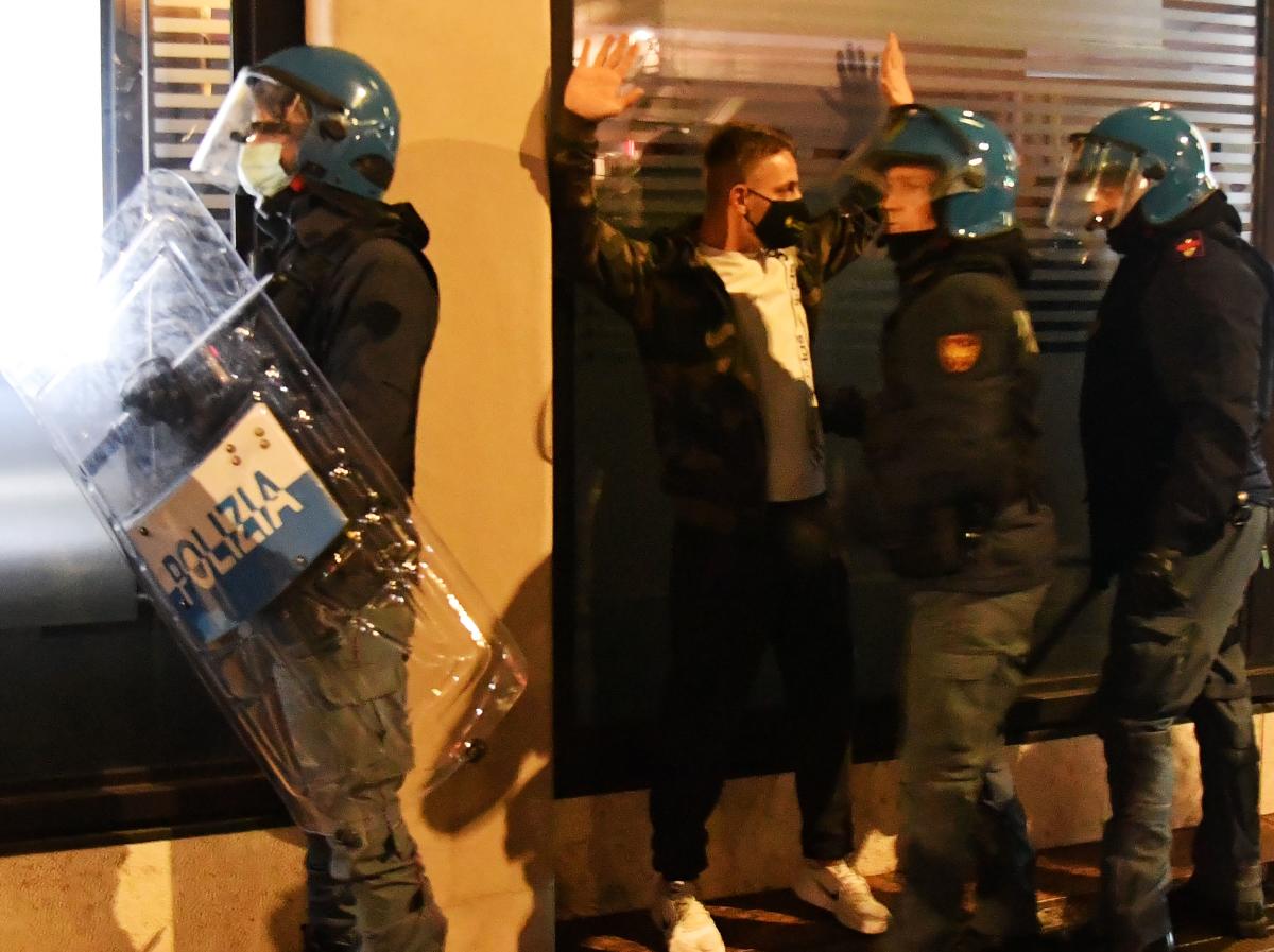 Italian police officers arrest an extreme far right Forza Nuova party activist during a protest against the government restriction measures to curb the spread of Covid-19, in Rome's central Piazza del Popolo. Credit: AFP Photo
