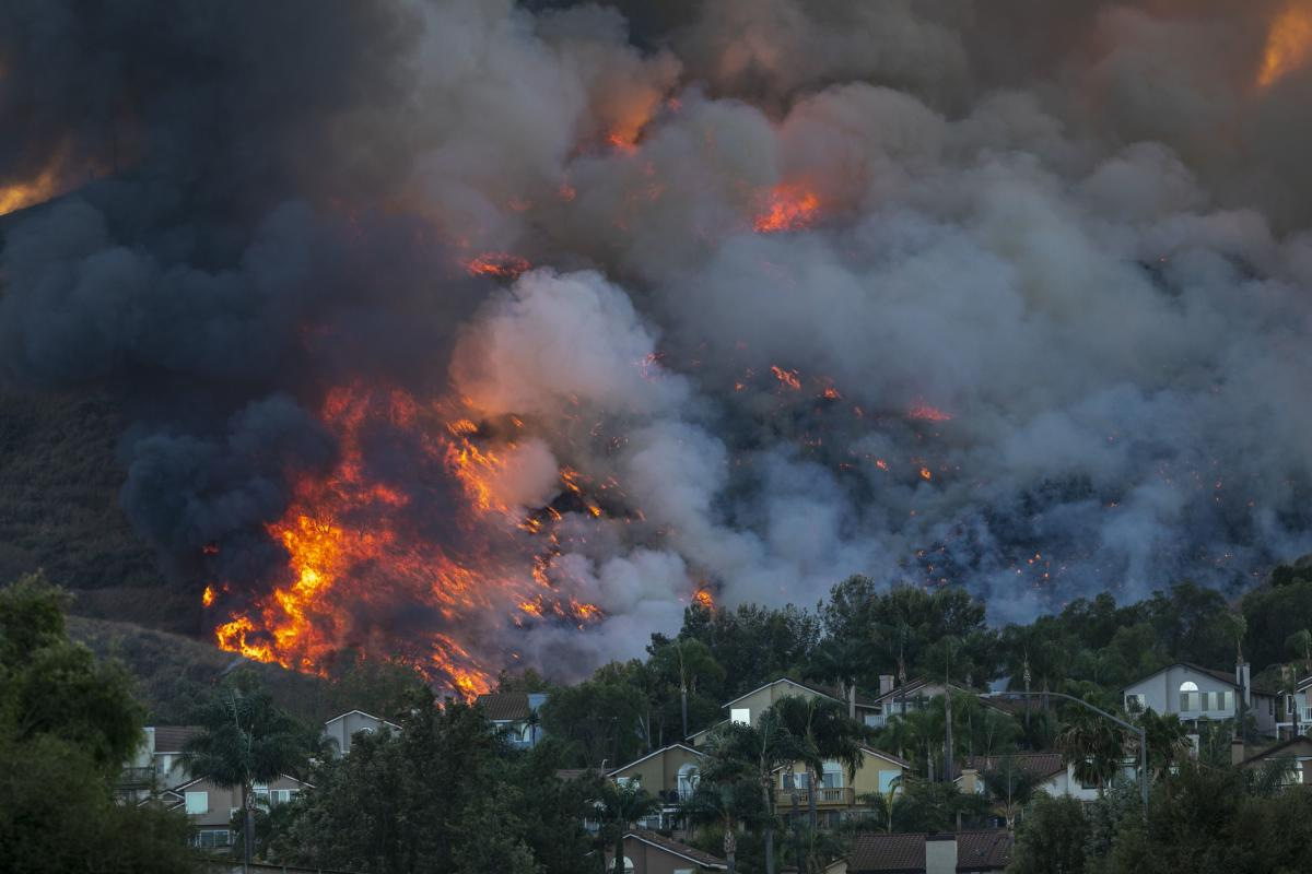 Strong Santa Ana Winds gusting to more than 90 miles per hour have driven the Blue Ridge Fire and Silverado Fire across thousands of acres, grounding firefighting aircraft, forcing tens of thousands of people to flee, and gravely injuring two firefighters. Credit: AFP Photo