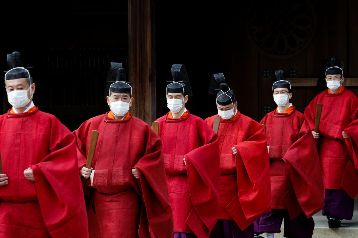 Priests wearing face masks as a precaution against the coronavirus disease (COVID-19) leave the main shrine after Japan's Emperor Naruhito and Empress Masako paying their tribute during a ceremony celebrating 100 years since the enshrinement of Emperor Meiji at Meiji Shrine in Tokyo, Japan. Credit: Reuters Photo
