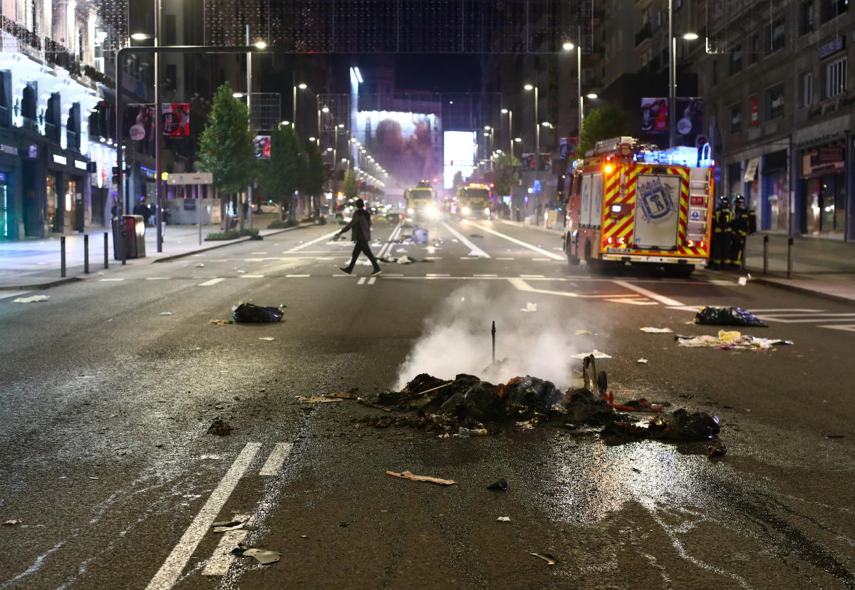 A pile of burned objects are seen on the road during a protest against the closure of bars and gyms, amidst the coronavirus disease outbreak, in Madrid, Spain. Credit: Reuters Photo