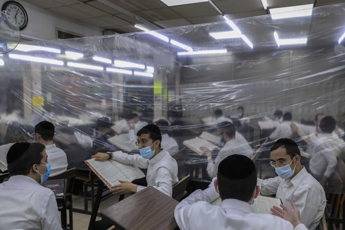As Israel entered lockdown in March, a video emerged showing 92-year-old rabbi Chaim Kanievsky, one of the world's most powerful, flanked by his grandson and top advisor Yaakov, professing ignorance about coronavirus and insisting religious schools remain open, which cast them as central figures in a debate that has consumed Israel throughout the pandemic. Credit: AFP Photo