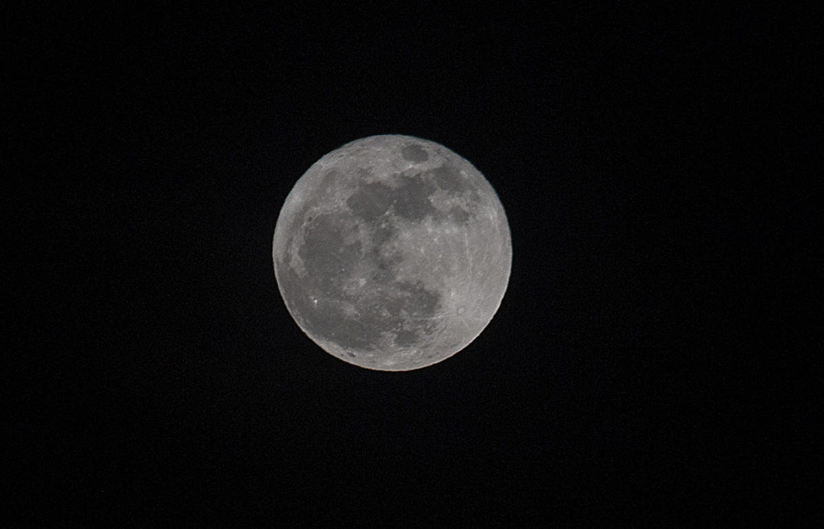 The “blue moon” rises over San Salvador on October 31, 2020, a cosmic phenomenon that according to astronomers will not be repeated until 2023. Credit: AFP Photo