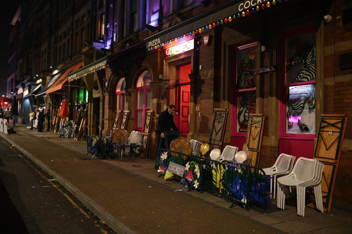 A proprietor takes in outdoor seating after closing time in Leeds, northern England, on the eve of a second Covid-19 lockdown in an effort to combat soaring infections. English pubs call last orders at the bar for a month on Wednesday evening, as the country effectively shuts down from November 5, for the second time this year. Boris Johnson insisted that the lockdown would end