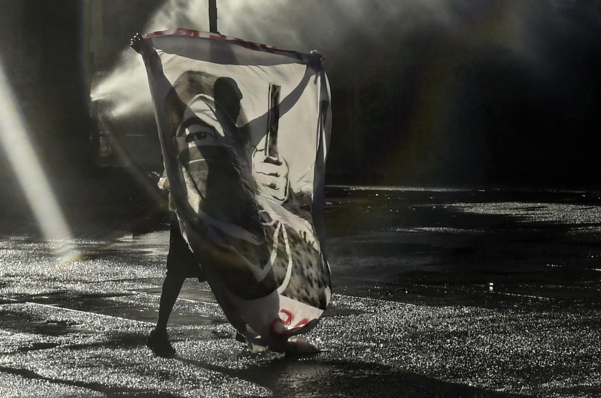 A demonstrator is sprayed by riot police during clashes following a protest against Chilean President Sebastian Pinera's government in Santiago. Credit: AFP Photo
