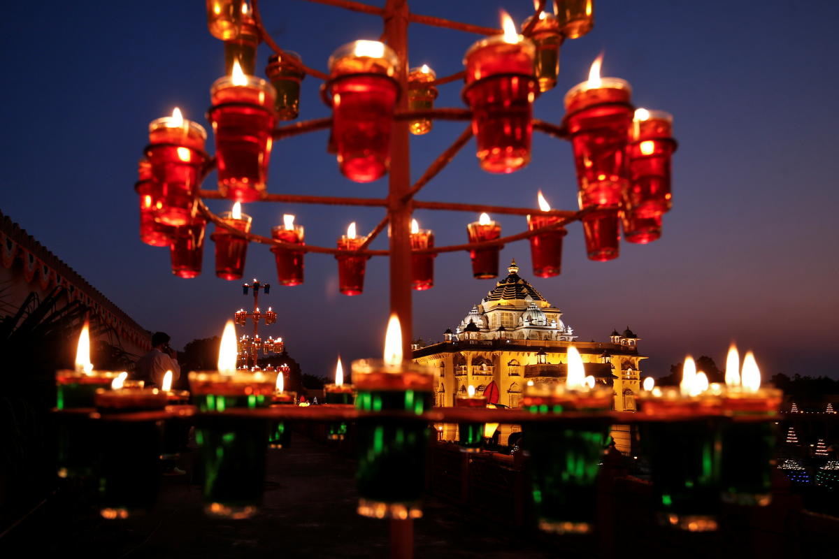 Devotees visit illuminated Akshardham temple on the eve of Diwali, the Hindu festival of lights, amidst the spread of Covid-19, in Gandhinagar. Credit: Reuters Photo