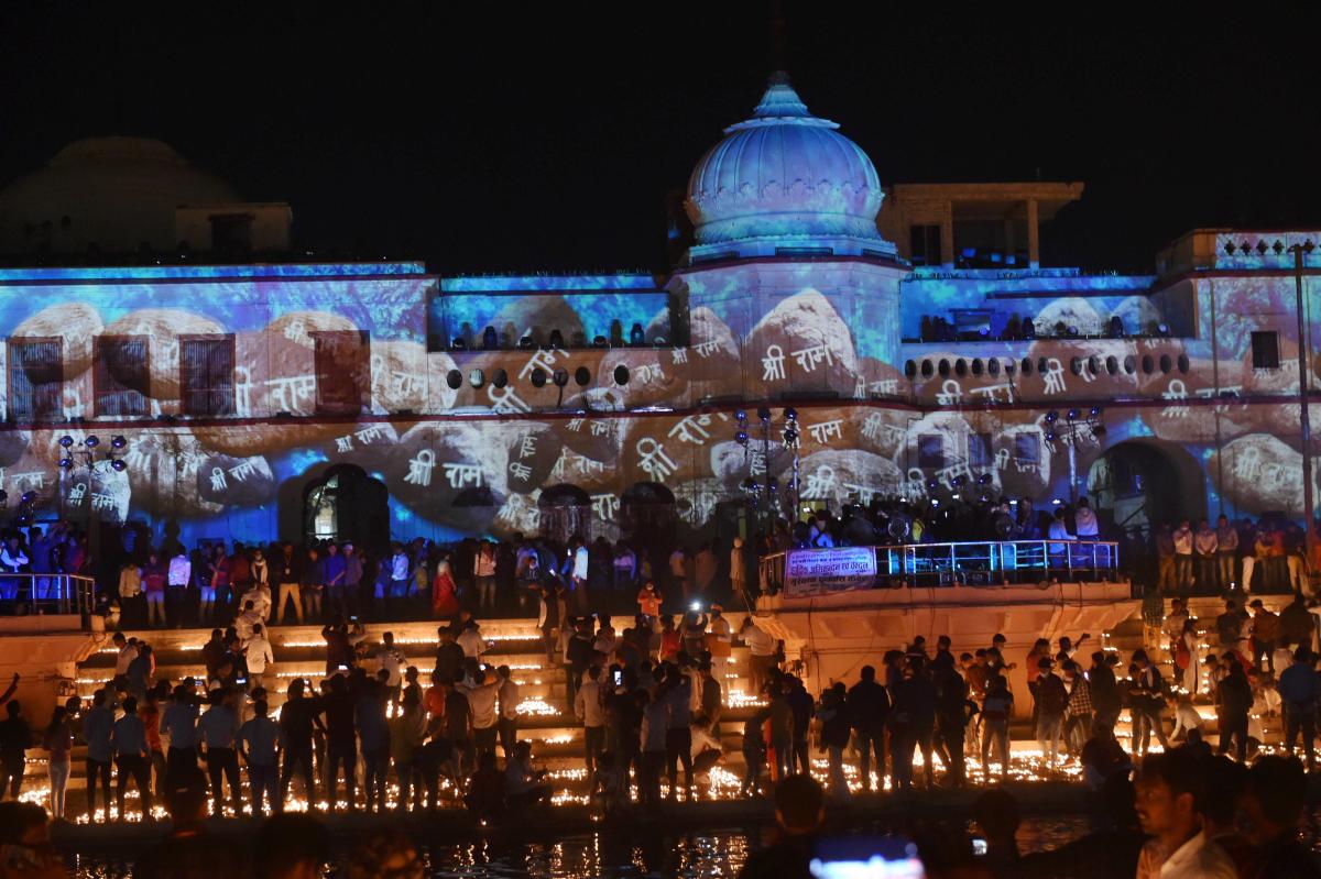 Devotees light earthen lamps on the bank of Saryu River during Deepotsav celebrations in Ayodhya. Credit: PTI Photo