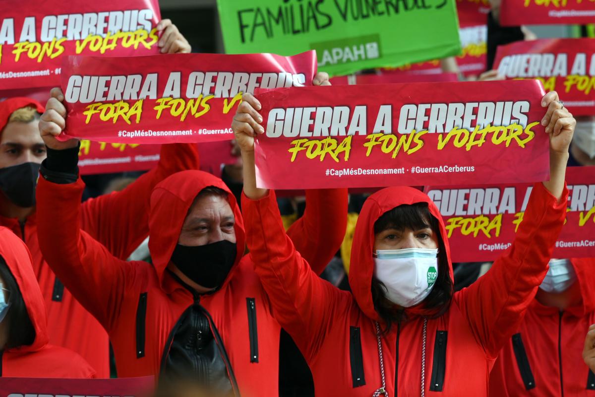 Members of several anti-eviction groups and movements pro the right to a good housing wear the red jumpsuit of the Spanish Netflix hit series La Casa de Papel (Money Heist), as they hold up banners reading