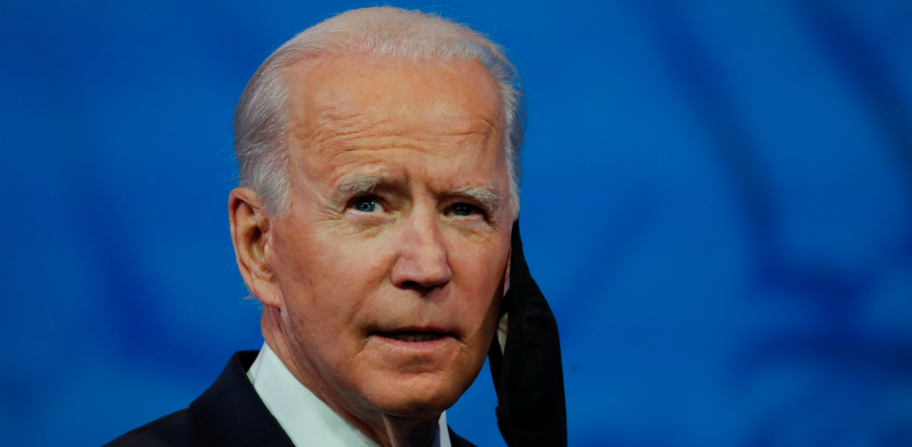 US President-elect Joe Biden takes off his protective face mask to deliver a televised address to the nation, after the US Electoral College formally confirmed his victory over President Donald Trump in the 2020 US presidential election, from Biden's transition headquarters in Wilmington, Delaware. Credit: Reuters