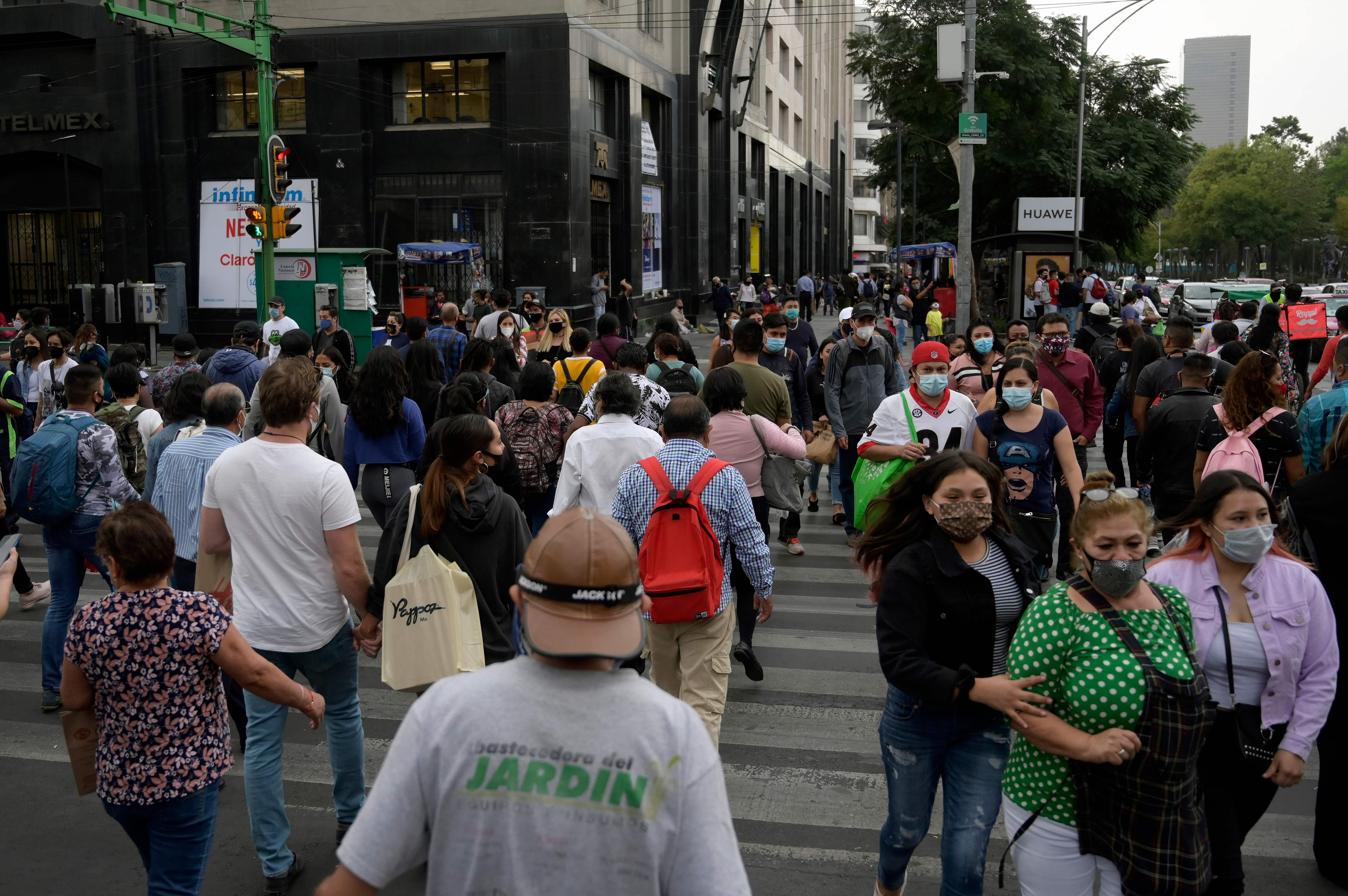 People walk in downtown in Mexico City amid the Covid-19 pandemic. Credit: AFP