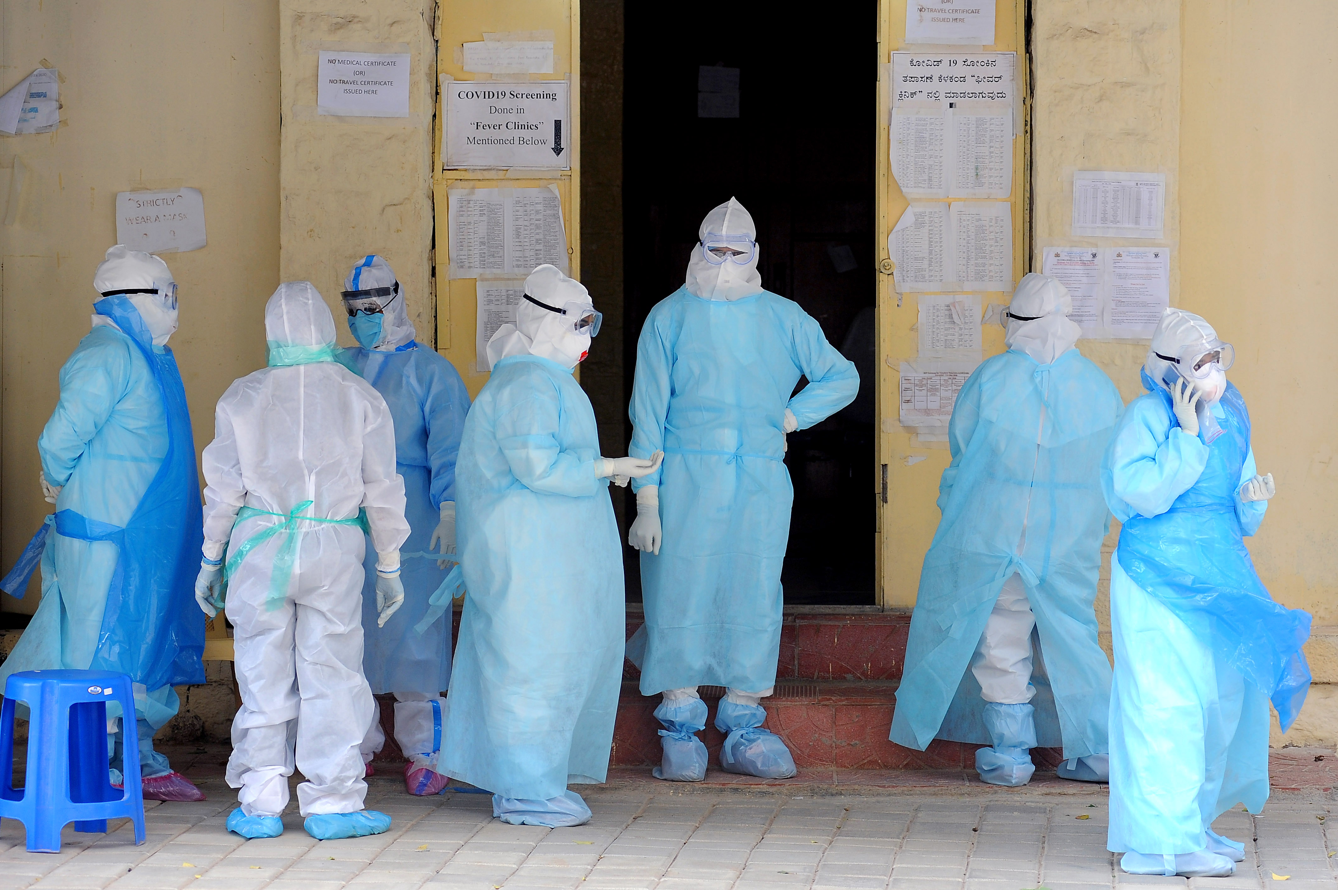 Karnataka ramps up testing | Medics wearing PPE stand outside the Covid-19 ward of Bengaluru's Victoria Hospital, as cases surge. Credit: DH Photo/ Pushkar V