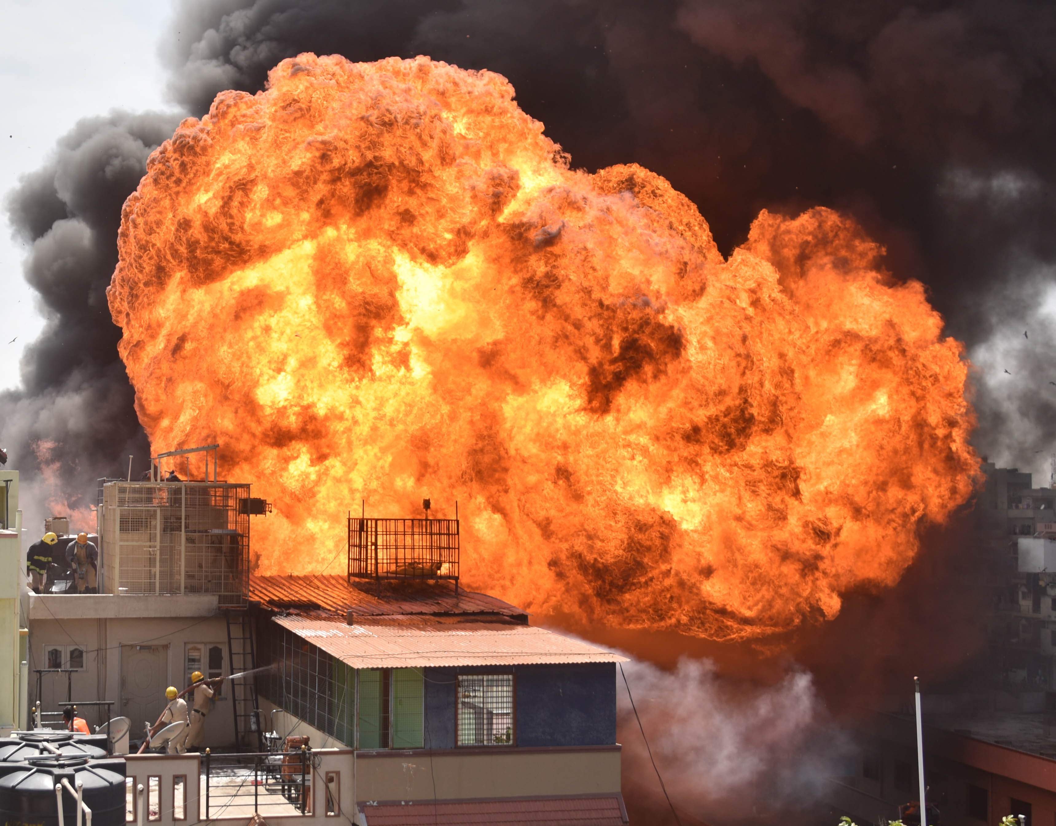 Amid a virus, some accidents | Orange flames are seen rising after a massive fire broke out in a chemical factory at New Guddadahalli near Mysore road in Bengaluru. Credit: Credit: DH Photo/ Janardhan B K