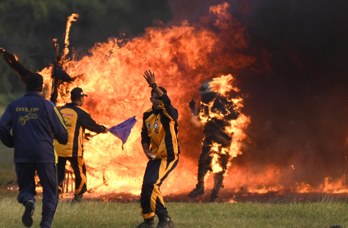 Through fire, ice and worse, life goes on | Captain Shivam Singh (right) of the daredevil IAF 'Tornadoes' motorcycle acrobatic team is engulfed in flames while trying to ride through a tunnel of fire in an attempt to break the Guinness Book of World Records in Bengaluru. Credit: DH Photo/ B H Shivakumar